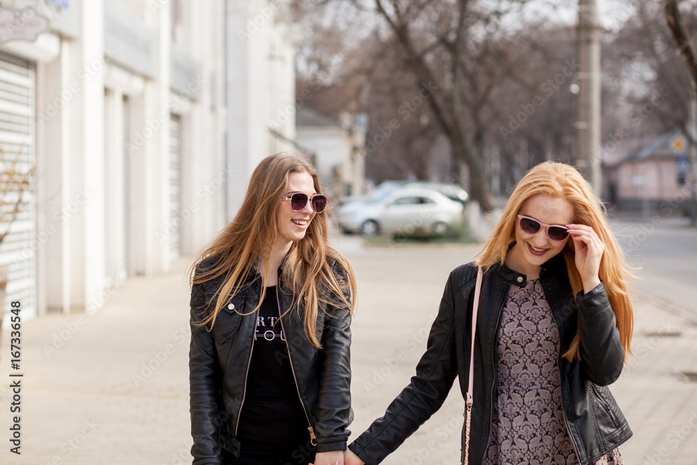 Two girl friends hanging out outside in the city. Youth and friendship  Stock Photo | Adobe Stock