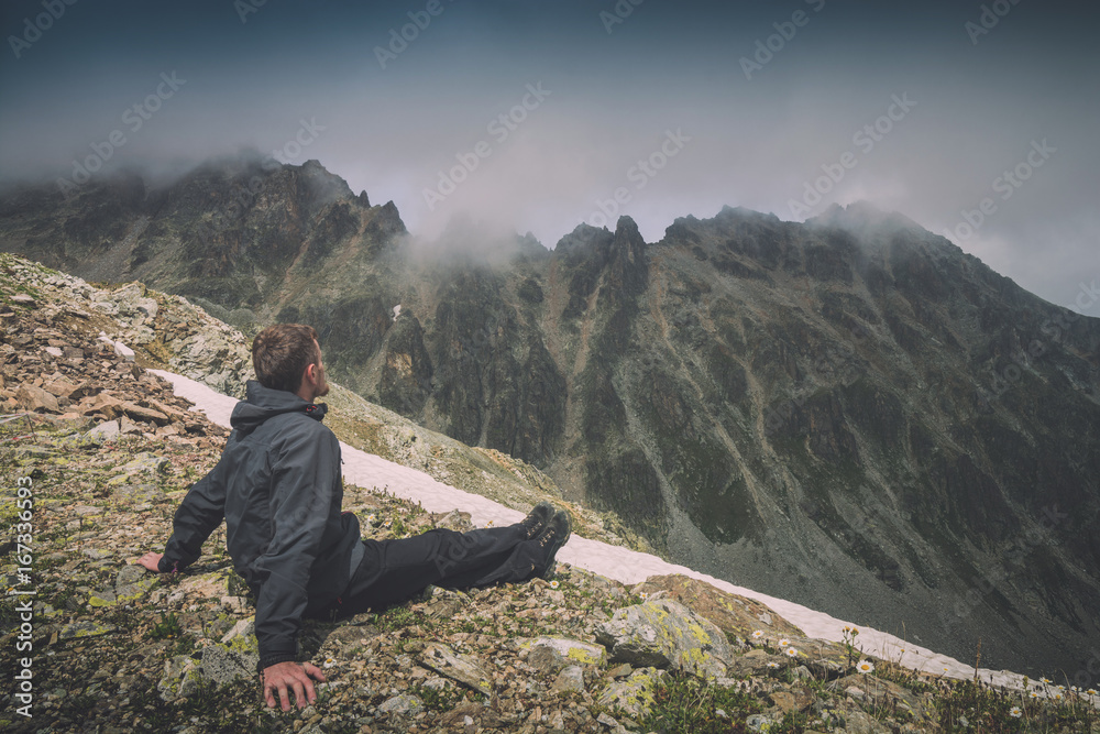 Hiker relaxing on top of a mountain. Instagram stylization