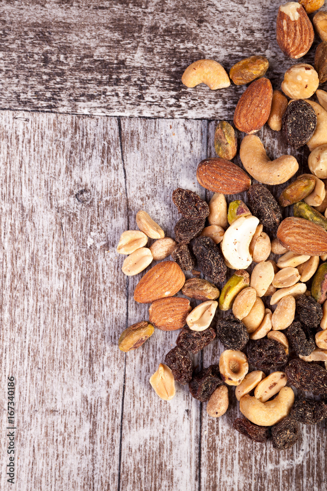 Delicious Mix of healthy raw nuts on wooden background in studio photo. Healthy organic snack