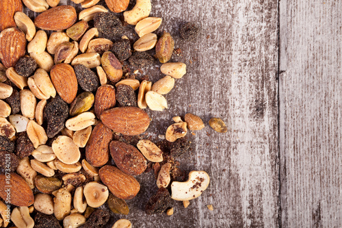 Over top view of Mix from healthy raw nuts on wooden background in studio photo. Healthy organic snack