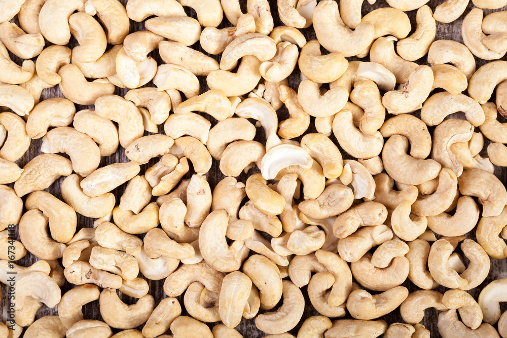 Over top view of Cashew nuts on wooden background in studio photo. Raw healthy food Over top view of Cashew nuts on wooden background in studio photo. Raw healthy food