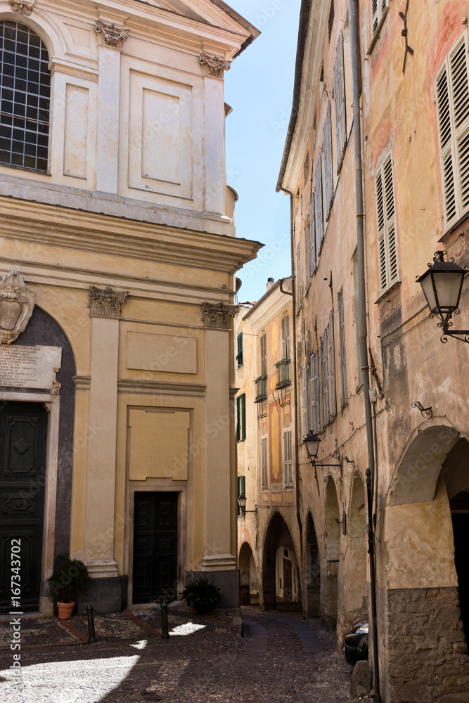 The historic centre of Taggia, medieval church square in old town, Liguria
