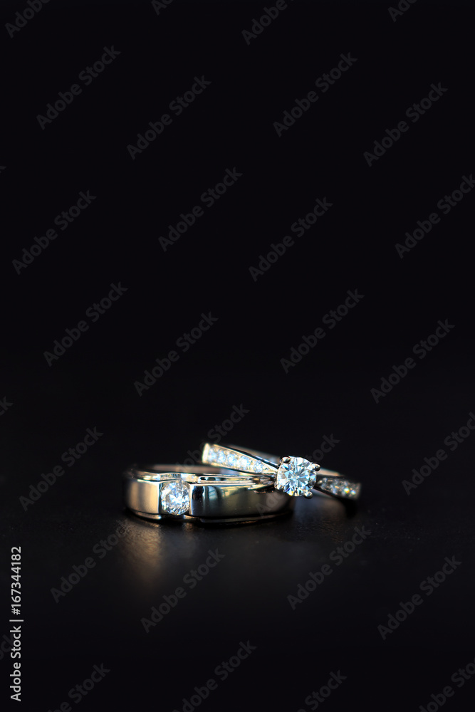 wedding ring on black table with soft-focud and over light in the background wedding ring on black table with soft-focud and over light in the background