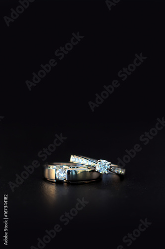 wedding ring on black table with soft-focud and over light in the background