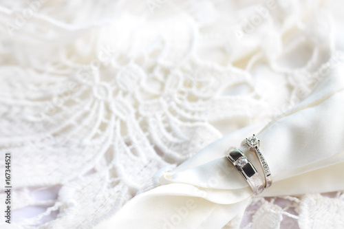 wedding ring on white table with soft-focus and over light in the background photo