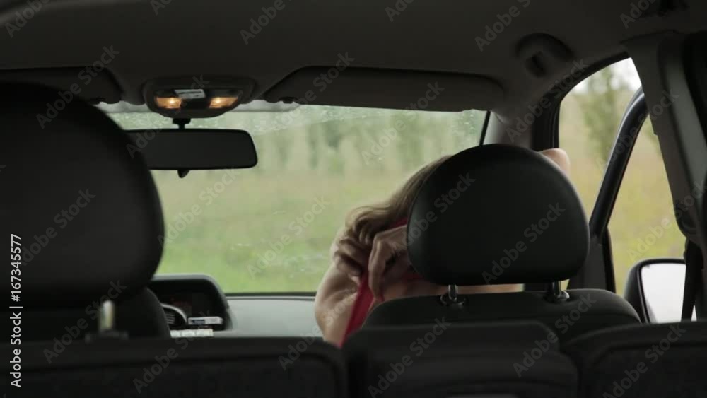 beautiful blonde woman dressed in a car. girl changes clothes in the cab beautiful blonde woman dressed in a car. girl changes clothes in the cab