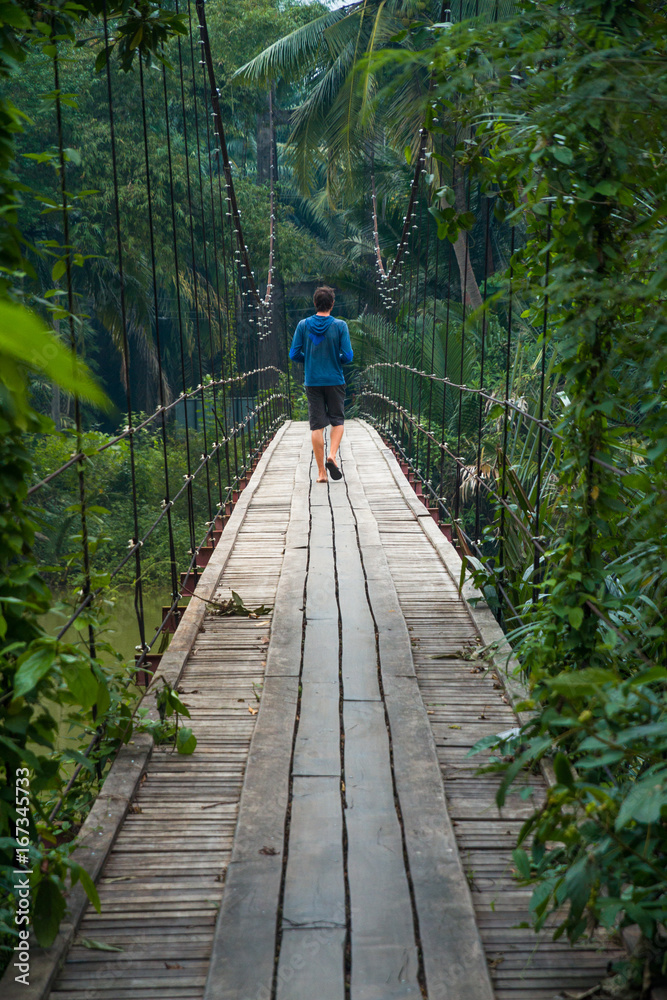 Fototapeta premium Walking on a suspension bridge in asia