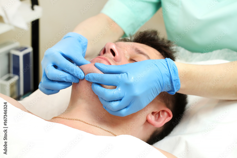 Man in the mask cosmetic procedure in spa salon Man in the mask cosmetic procedure in spa salon