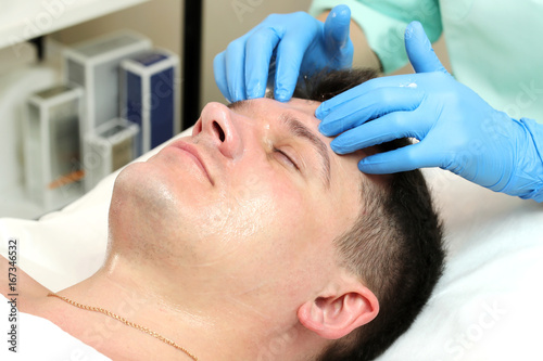 Man in the mask cosmetic procedure in spa salon 