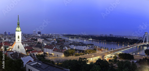 Panoramic view of Bratislava city with St. Martin's Cathedral and Danube river at night