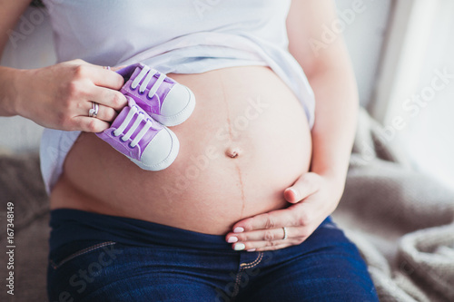 close up woman touching her pregnant belly