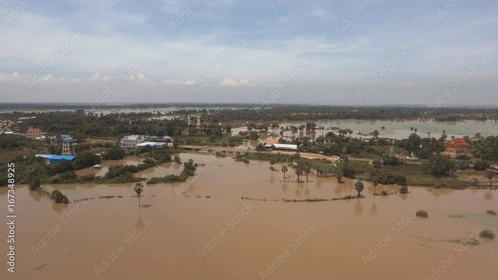 drone view : flying backwards over flooded fields with a small bridge in the background. drone view : flying backwards over flooded fields with a small bridge in the background.