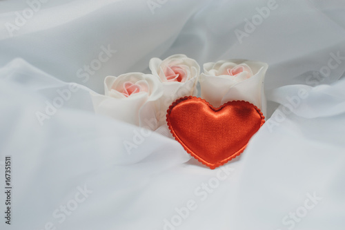Light wedding background with roses and red heart