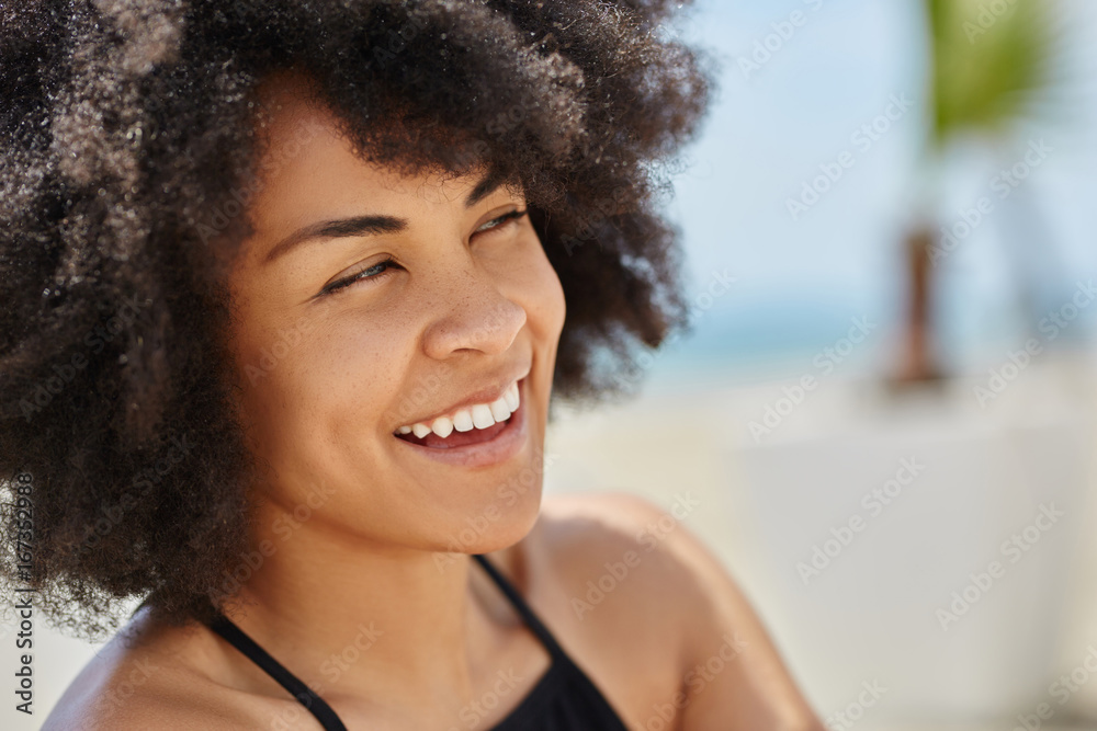 Beautiful afro american woman looking away laughing