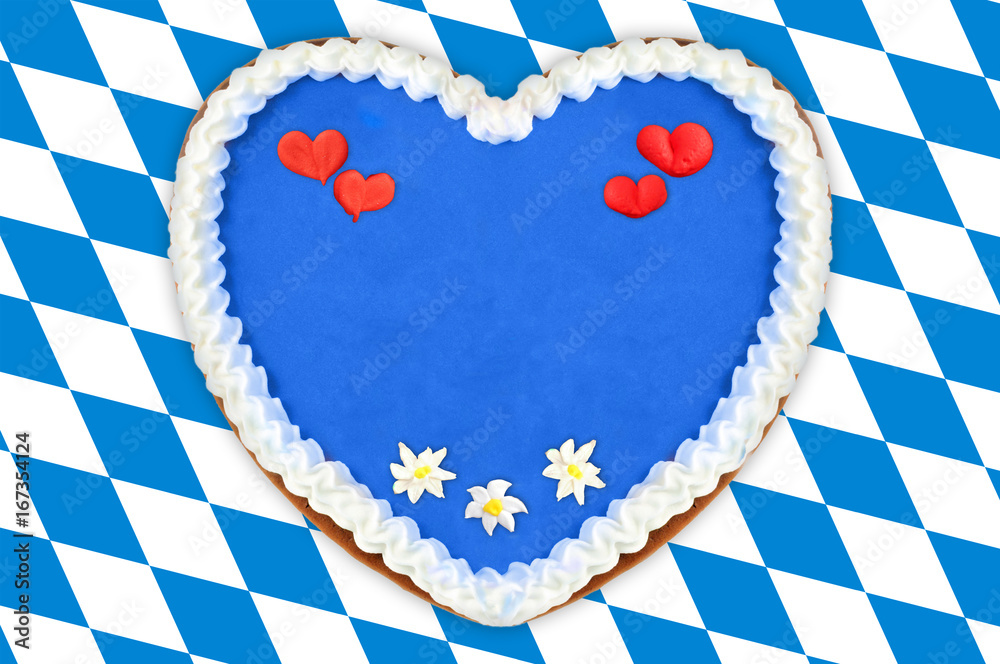 Obraz premium Oktoberfest Gingerbread heart with copy space on bavarian white blue flag.