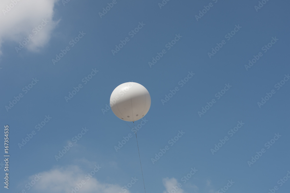 White balloons in the sky.