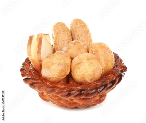 Braided bread basket with delicious buns on white background