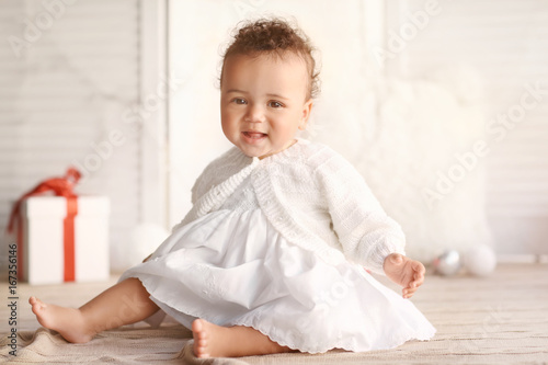 Cute little baby sitting on...