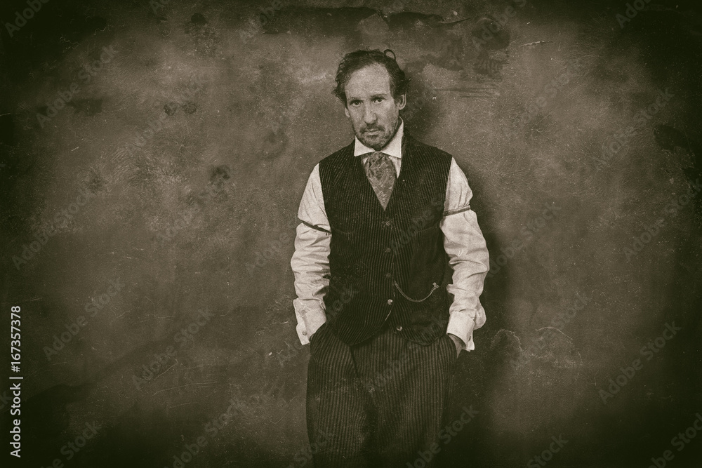 Fototapeta premium Classic wet plate photo of vintage 1900 western man leaning against wall.
