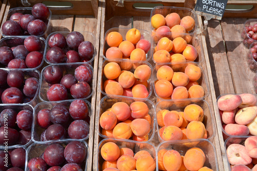 Punnets of apricots plums and peaches outside greengrocers