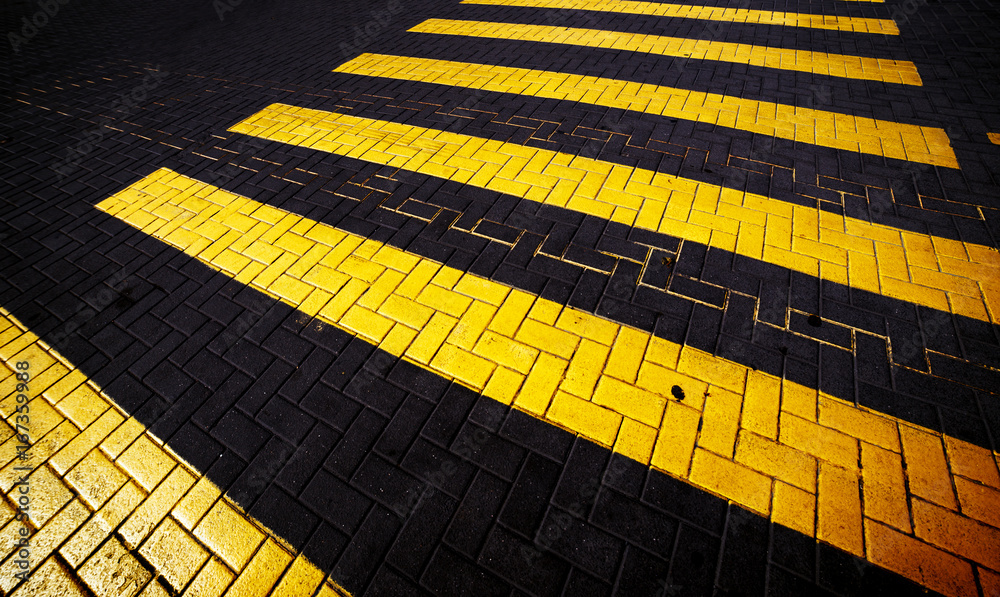 Yellow crosswalk on the road, abstract background.