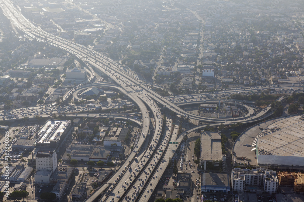 Smoggy afternoon aerial view of Harbor 110 and Santa Monica 10 freeways in downtown Los Angeles, California.  