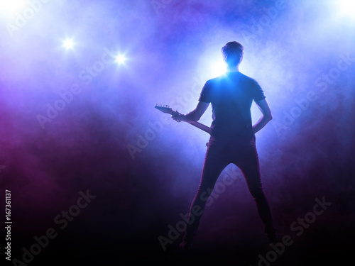 Silhouette of guitar player on stage 