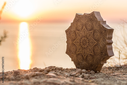 Mandala with a beautiful sea and sunset background photo