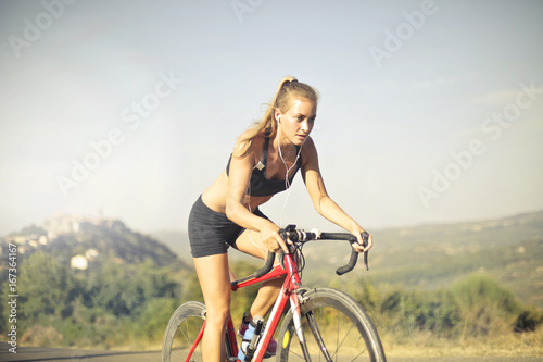 Fototapeta Naklejka Na Ścianę i Meble -  Sporty girl riding in the countryside