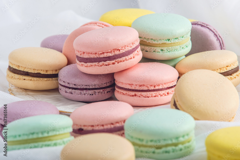 Colorful macarons on a white background. French dessert Colorful macarons on a white background. French dessert