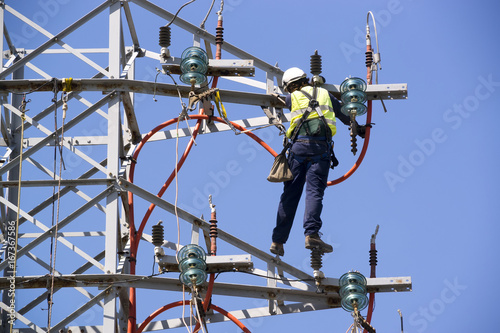 electric tower of high voltage Is disassembled by specialists worker