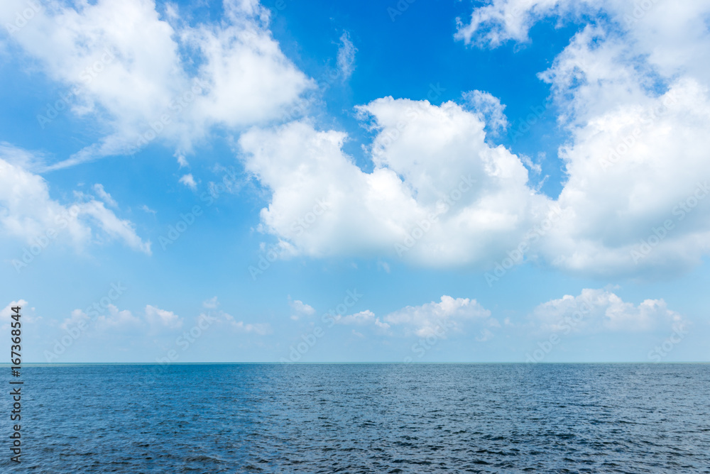White cloud on the blue sky with sea background