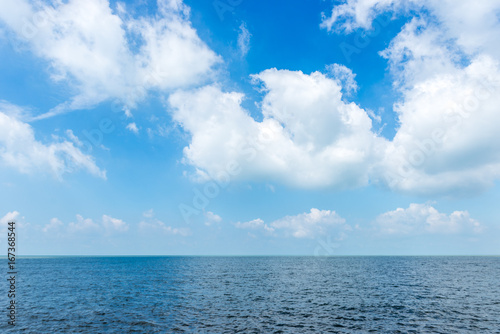 White cloud on the blue sky with sea background