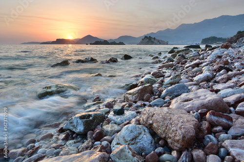 Sunset at the beach. Crvena Glavica. Budva riviera. Montenegro photo