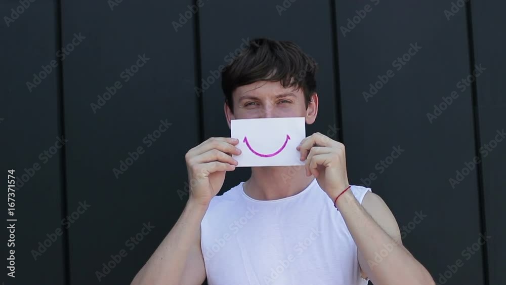 Positive emotion on the face of the guy. Smile on paper