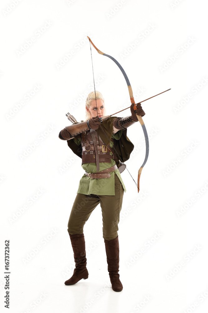 full length portrait of a blonde girl wearing green and brown medieval costume, holding a bow and arrow. isolated on white background. full length portrait of a blonde girl wearing green and brown medieval costume, holding a bow and arrow. isolated on white background.