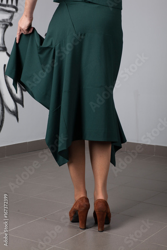 Details of women's clothing: green skirt on the model 