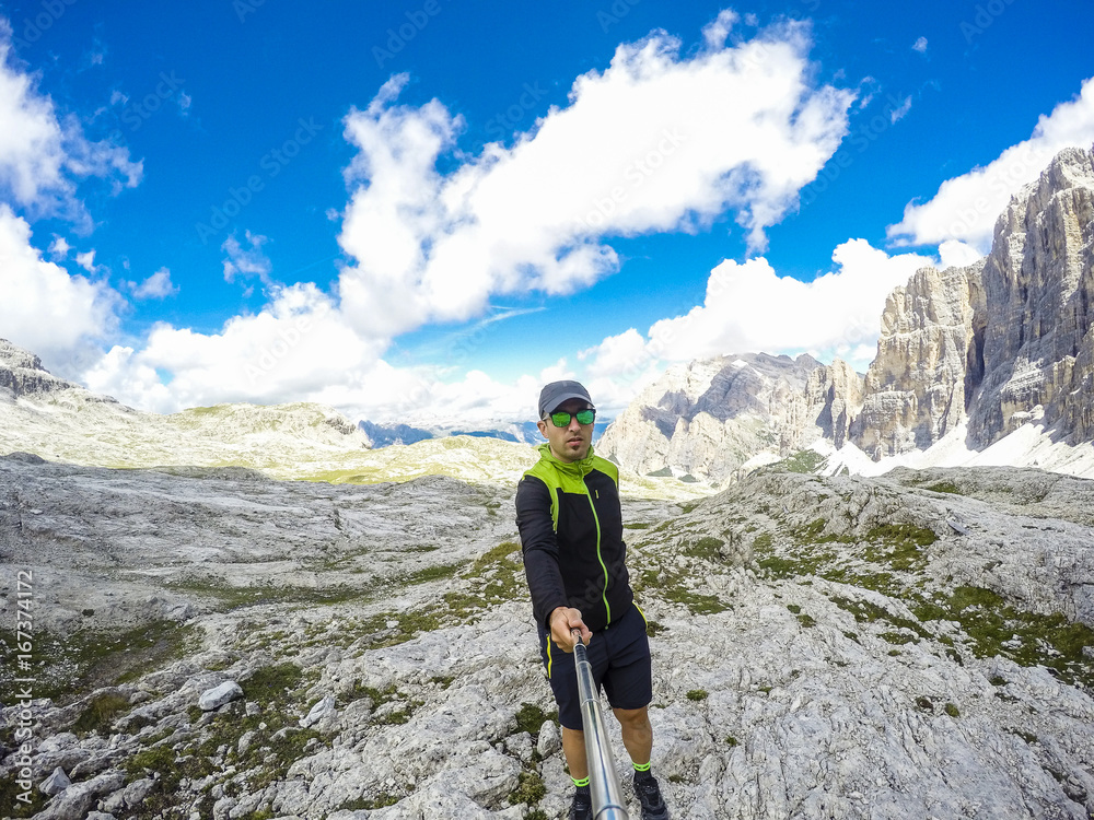 Young hiker man take a selfie on mountain landscape. Original Point of view Young hiker man take a selfie on mountain landscape. Original Point of view