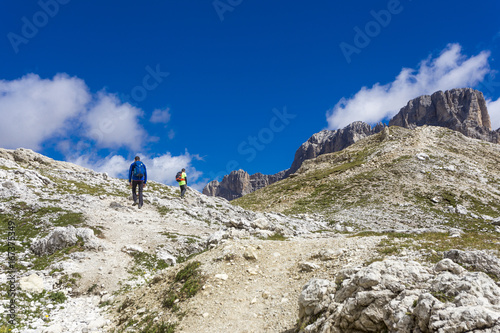 Dolomites, pair of hikers on path in summer season