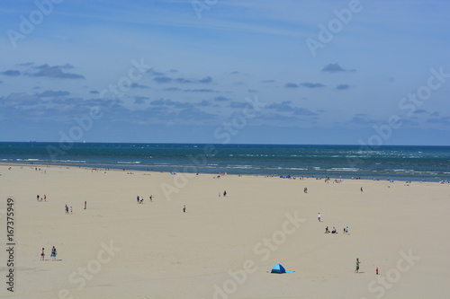 A long beach with people on it in The Netherlands