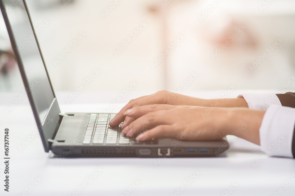 A business woman analyzing investment charts at his workplace and using his laptop A business woman analyzing investment charts at his workplace and using his laptop