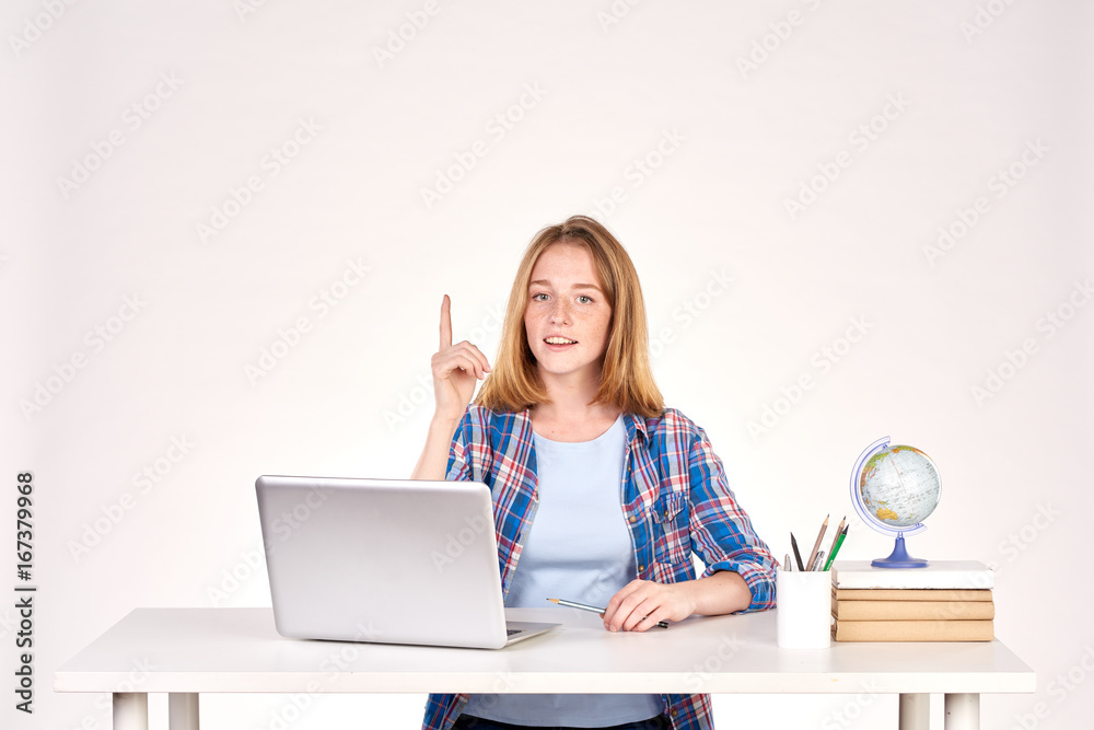 Portrait of teenage red-haired student sitting at desk Portrait of teenage red-haired student sitting at desk
