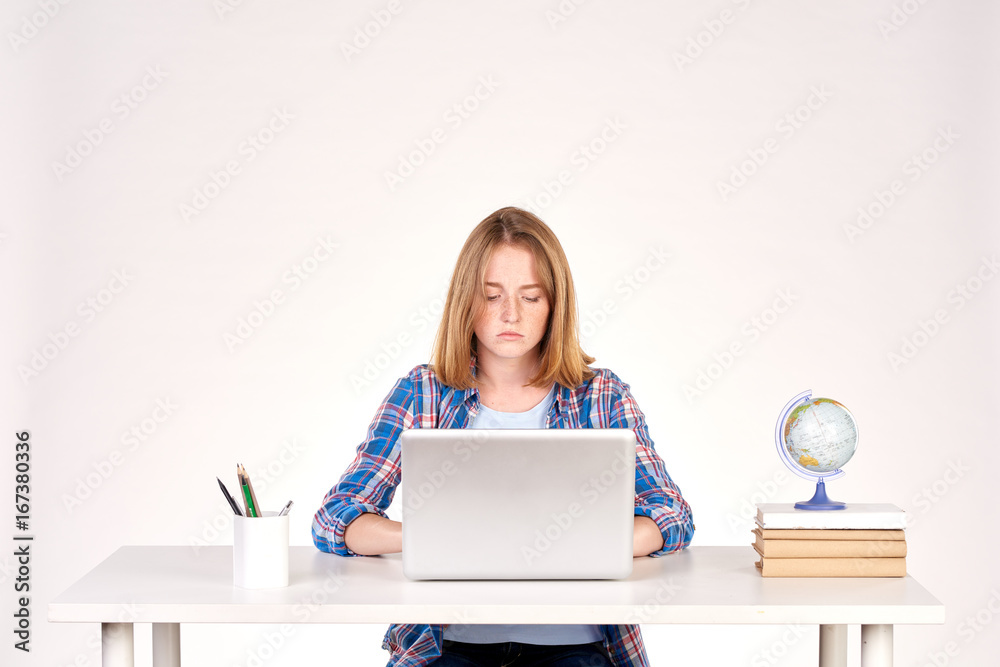 Portrait of teenage red-haired student sitting at desk Portrait of teenage red-haired student sitting at desk