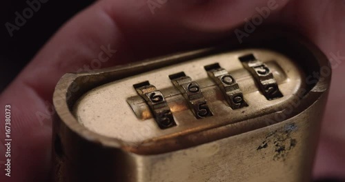 Person spins combination lock, close up