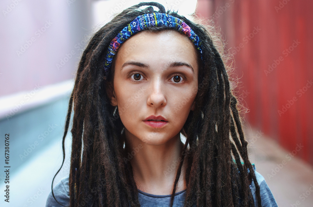 Fototapeta premium Portrait of a beautiful girl with dreadlocks