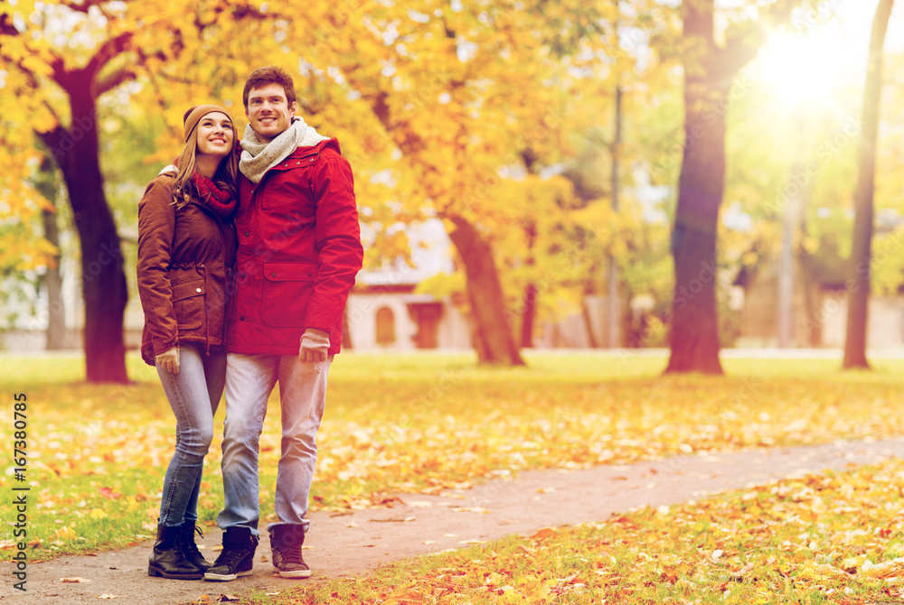 happy young couple walking in autumn park happy young couple walking in autumn park