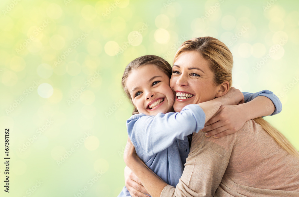 happy girl with mother hugging over lights happy girl with mother hugging over lights