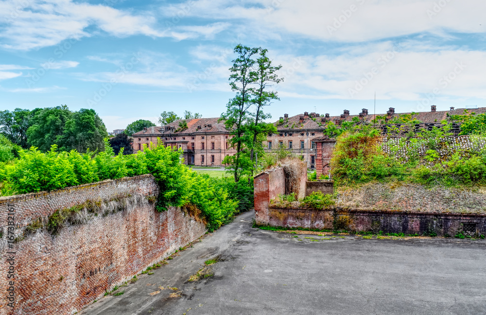 View of abandoned and ruined buildings of the ancient damaged Cittadella of Alessandria in Italy. HDR effect.
