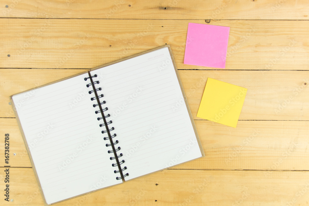 Empty book and post-it on wood table. copy space Empty book and post-it on wood table. copy space