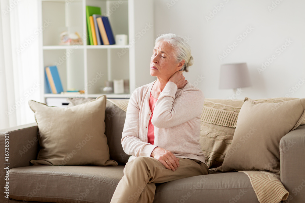 senior woman suffering from neck pain at home senior woman suffering from neck pain at home